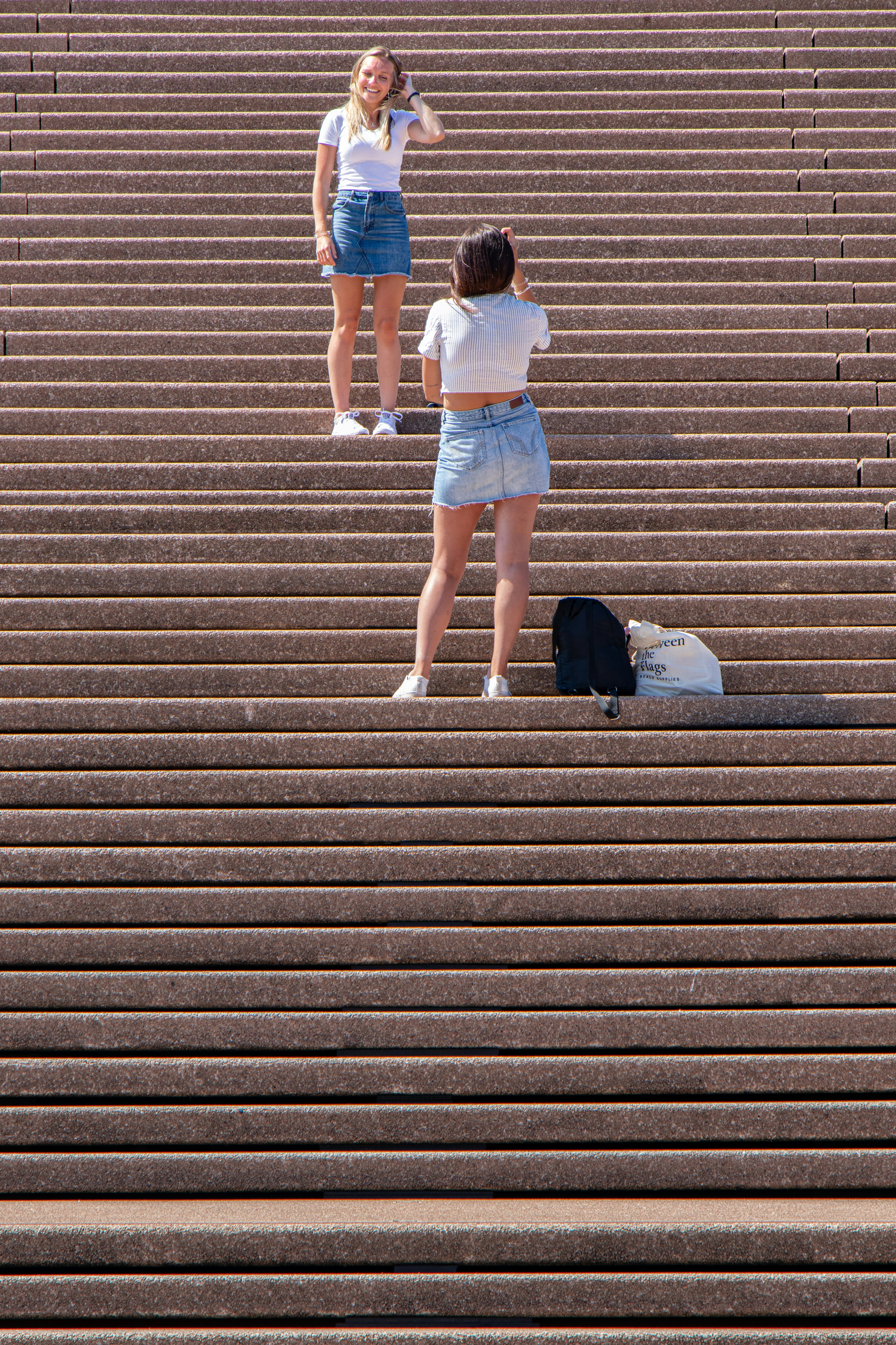 two women standing on stairs